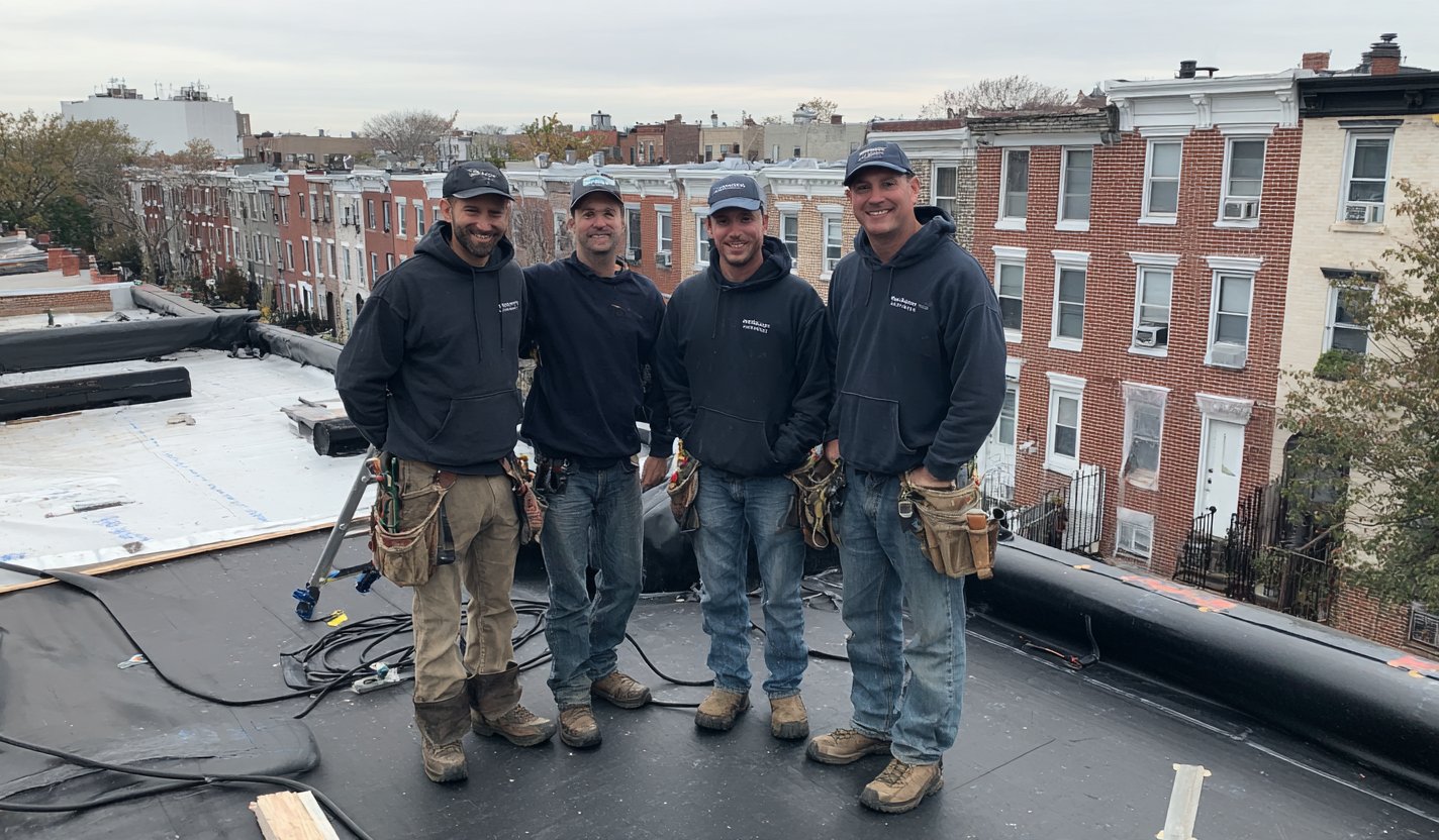 The Flat Roofers NY team on a flat roof in Queens