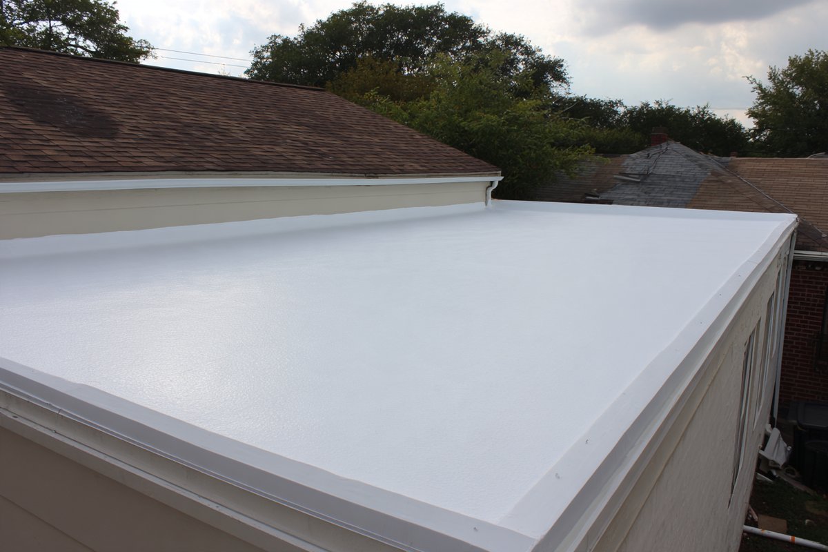 After: white silicone coating over EPDM on a Bayside garage roof