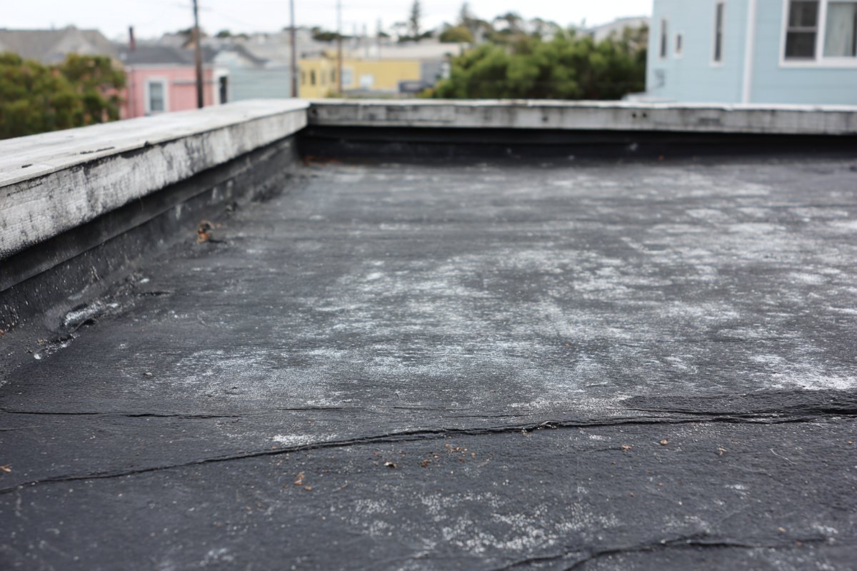 Before: aged, chalky EPDM on the same Bayside garage roof