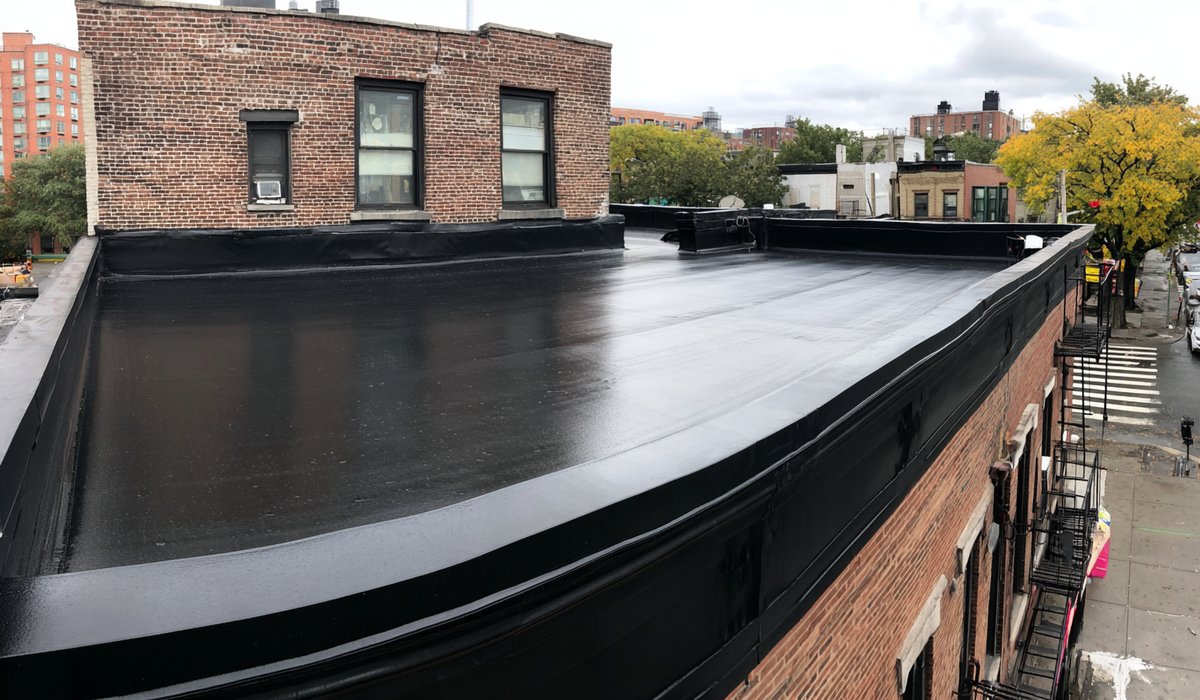 New fully adhered EPDM roof with new edge metal on a mixed-use storefront building in Elmhurst