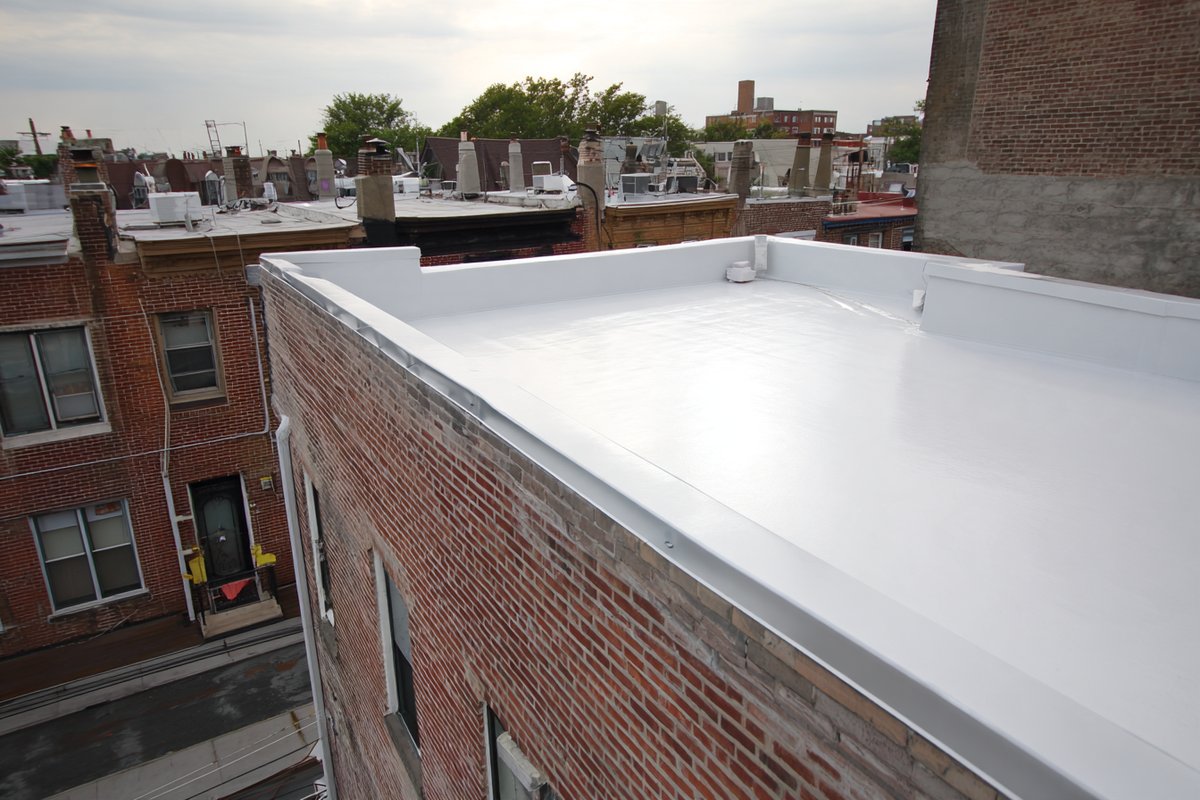 Finished flat roof on an attached rowhouse in Astoria, new membrane and flashing at the parapet