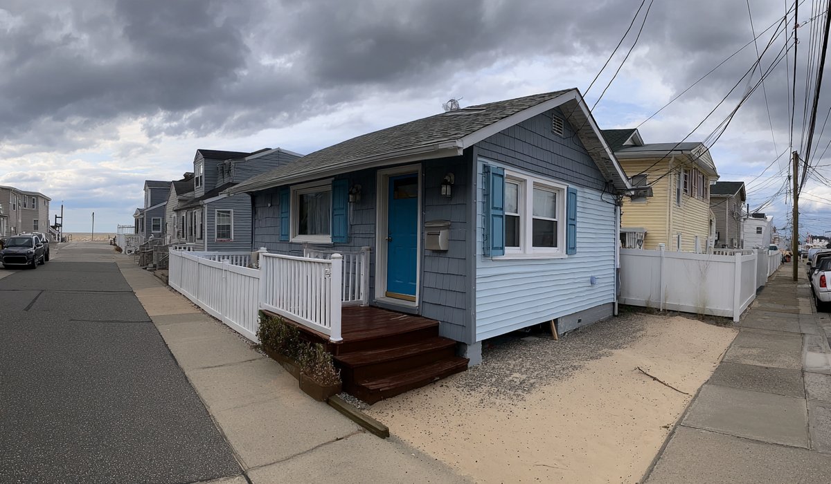 Small single-storey beach bungalow in Rockaway Beach with an asphalt shingle roof, a short walk from the boardwalk